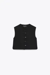 Top tipo chaleco negro de Zara Woman Collection, con cuello redondo y sisa. Presenta costuras a contraste y cierre frontal con botones.