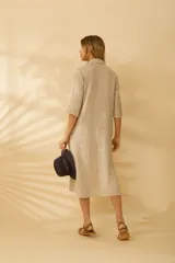 Camisa larga de lino color beige, con botones de nácar y corte holgado, que puede usarse como vestido o túnica.