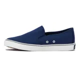 Zapatilla tipo slip-on de lona color azul marino, con suela de goma blanca y detalles en gris. Presenta un logo de velero en el talón y un detalle de costura ondulada en el empeine.