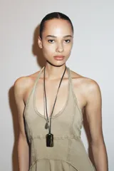 Vestido corto color beige con cuello halter y falda con godets.