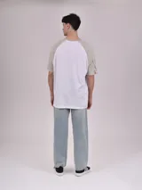 Remera blanca con mangas ranglán color gris y estampado frontal con la palabra "Michigan" en verde.