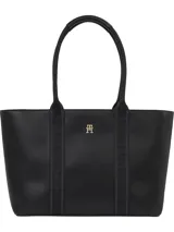 Bolso tipo tote negro de Tommy Hilfiger con cierre de cremallera, doble asa superior con inscripción de la marca y logo dorado en el frente.