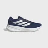 Championes de running Adidas Supernova Ease, color azul marino con las tres franjas características en plateado. Cuentan con una mediasuela gruesa de espuma blanca con tecnología Dreamstrike+.