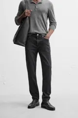 Pantalón de jean azul oscuro, corte slim fit, tiro medio, cinco bolsillos, tejido elástico y efecto lavado.