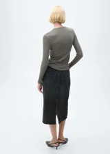 Falda midi de jean negro con cintura alta, presillas para cinturón, cierre frontal con cremallera y botón, cinco bolsillos y corte recto.