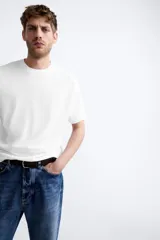 Jersey de punto color marrón oscuro, de corte relajado (relaxed fit), con cuello redondo y manga corta.