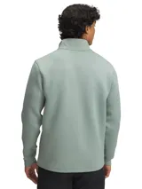 Buzo deportivo Under Armour Drive Pro, color verde agua, con cierre parcial frontal, cuello alto y logo en el pecho.