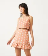 Blusa musculosa cropped color salmón con estampado de mandalas blancas, tirantes finos ajustables y lazo en la espalda.