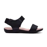 Sandalias bajas negras con suela color piel y ajuste con elástico en el tobillo.