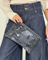 Cartera con superficie de lentejuelas de doble cara que cambian de color al tacto, con bordes de cuero.