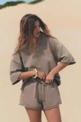 Shorts de tiro alto confeccionados en tejido con efecto lavado, cintura elástica ajustable con cordones, bolsillos laterales de vivo y tejido combinado en rib a tono.