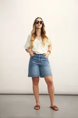 Blusa rosa de lino con escote cruzado en V y mangas cortas. Incluye un collar con cordón negro y dije dorado.