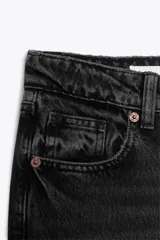 Pantalón de jean celeste claro, de tiro bajo, corte wide leg y largo hasta el tobillo. Tiene cinco bolsillos, cierre frontal con cremallera y botón metálico.