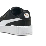Championes Puma Carina 3.0, color negro con franja blanca en el lateral y suela blanca.