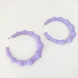 Argollas tipo bambú en resina mate de color lila, con un diseño texturizado.