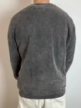 Buzo gris con efecto lavado y estampado con la palabra "OPTIMIST" en color salmón.