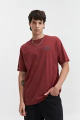 Remera color ladrillo de manga corta con cuello redondo y estampado pequeño en el pecho.