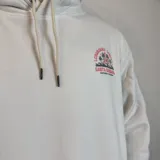 Canguro blanco con capucha y cordones ajustables. Estampado en la espalda con palmeras, olas y texto "Longboard Contest Santa Barbara Southern California".