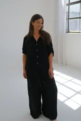 Camisa negra de mangas cortas con botones.