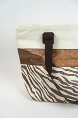 Bolso tipo tote con estampado de estrellas negras sobre fondo beige y una franja horizontal negra con glitter.