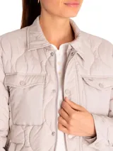 Campera color rosa pálido con diseño acolchado en forma de hojas, cuello camisero, cierre frontal con botones a presión, dos bolsillos de parche en el pecho y corte recto.