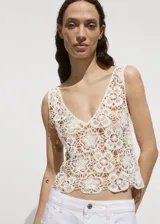 Top de crochet color blanco con escote en V y sin mangas.