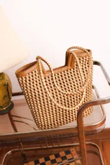 Bolso tipo tote de cuero color tostado, con diseño trenzado a mano.