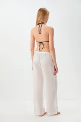 Pantalón de lino color rojo, de corte ancho y tiro alto, con cintura elástica ajustable con cordón.