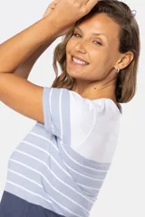 Remera de manga corta con cuello redondo, con rayas horizontales en color celeste y blanco en la parte superior y color azul en la parte inferior.