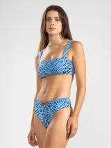 Top de bikini estilo bandeau con breteles anchos, estampado con diseño animal print que combina cebra y leopardo en tonos de azul. Incluye almohadillas removibles y protección UV50.