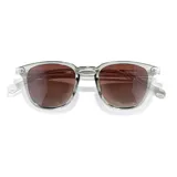 Lentes de sol Sunski modelo Tango, con montura transparente grisácea y lentes marrones degradé.