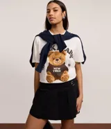 Short pollera corto de bengalina color negro, con pliegues frontales y detalle de hebilla lateral.