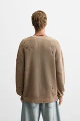 Sweater color marrón claro con efecto lavado ácido y roturas. De corte relajado, cuello redondo y mangas largas.