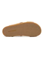 Sandalias bajas color beige con tiras cruzadas y detalle de nudo en el empeine.