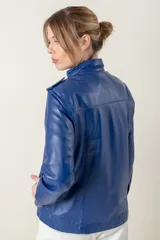 Campera roja de cuero ovino italiano, con charreteras en los hombros, bolsillos laterales, broches ocultos en el frente y broches a la vista en cuello y puños.