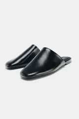 Zapato plano destalonado de piel color negro, con punta redonda y suela de 1,5 cm.