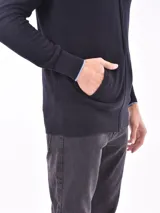 Campera negra con cierre frontal, cuello alto y puños con ribete celeste.