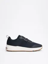 Zapatillas Tommy Hilfiger de running, color azul marino, con exterior de punto y poliéster, suela de goma blanca y detalles distintivos de la marca en el talón.