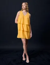 Vestido corto de gasa color amarillo, con escote en V, sin mangas y forro interno a tono.