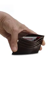 Tarjetero marrón oscuro de cuero liso con tres compartimentos para tarjetas de cada lado y un espacio central para billetes o monedas.