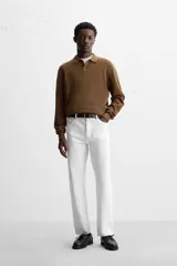 Polo marrón de punto con hilatura de algodón, corte relaxed fit, cuello solapa con cierre frontal de botonadura, manga larga y acabados en rib.