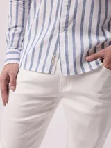 Camisa de manga larga a rayas verticales azules y blancas, con cuello abotonado y bolsillo en el pecho. Confeccionada en lino y algodón.