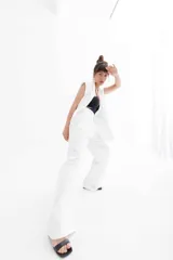 Pantalón negro de vestir de corte palazzo con cintura alta y bolsillos laterales.