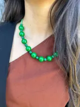 Collar corto con cuentas grandes de acrílico color verde esmeralda y cuentas pequeñas color verde agua. Se cierra con cadena de acero quirúrgico y ganchito para regular el largo.