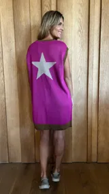 Vestido corto fucsia de tejido de punto, con cuello redondo y sisas con ribete marrón. Estampado de estrella grande color gris en la espalda.