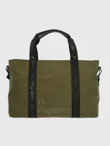 Bolso tipo tote verde militar con estampado del logo de la marca Hush Puppies en negro. Tiene doble asa corta negra y correa larga ajustable con el nombre de la marca en negro sobre verde.