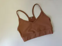 Top deportivo acanalado color marrón claro, con breteles finos y espalda deportiva.