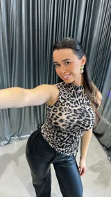 Top ajustado con estampado animal print, cuello alto y sisas amplias.