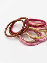 Pack de 12 coleros elásticos de colores rosa, dorado, marrón y bronce con detalles de brillo.