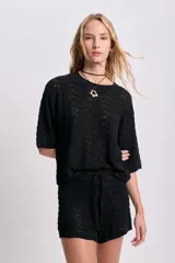 Top de punto crochet color negro con mangas cortas y cuello redondo.